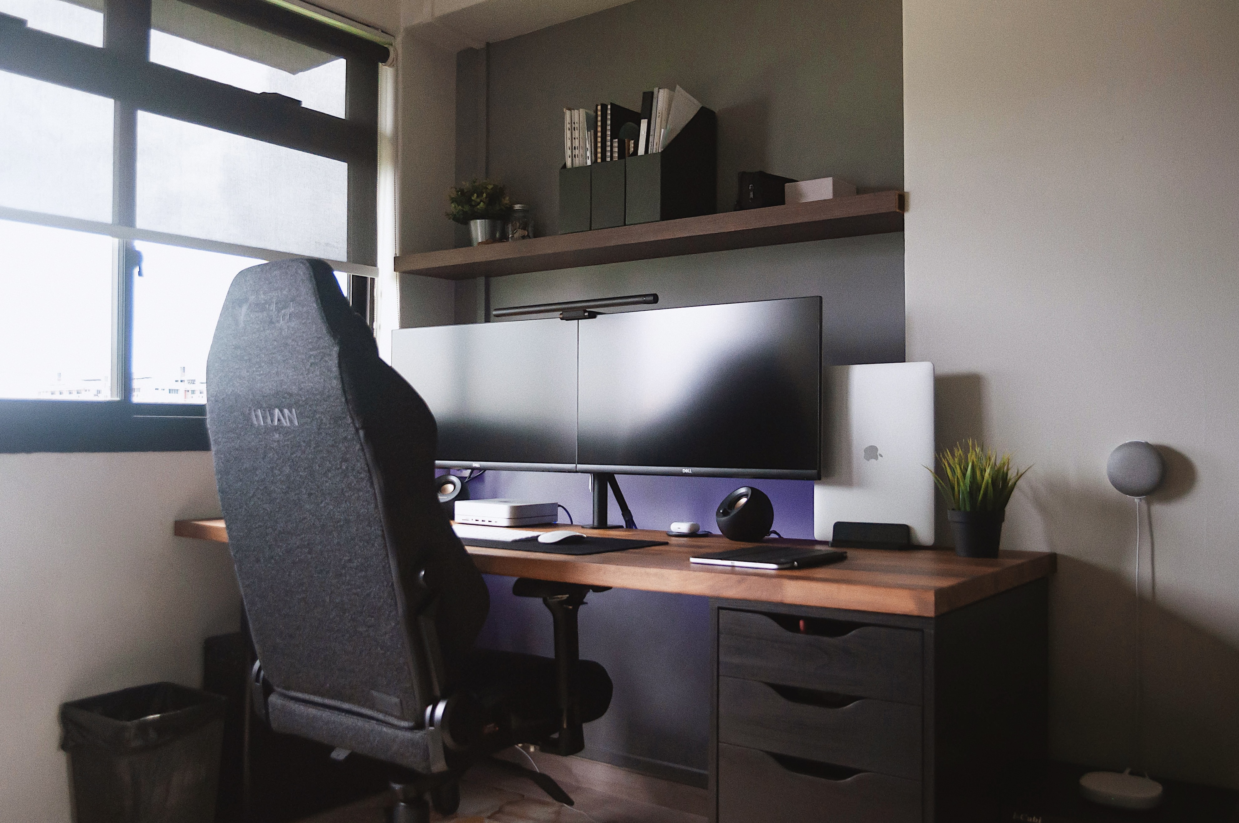 A Graphic Designer’s Humble Abode - Modern workspace, ergonomic chair, dual monitors, sleek design, ambient lighting, indoor