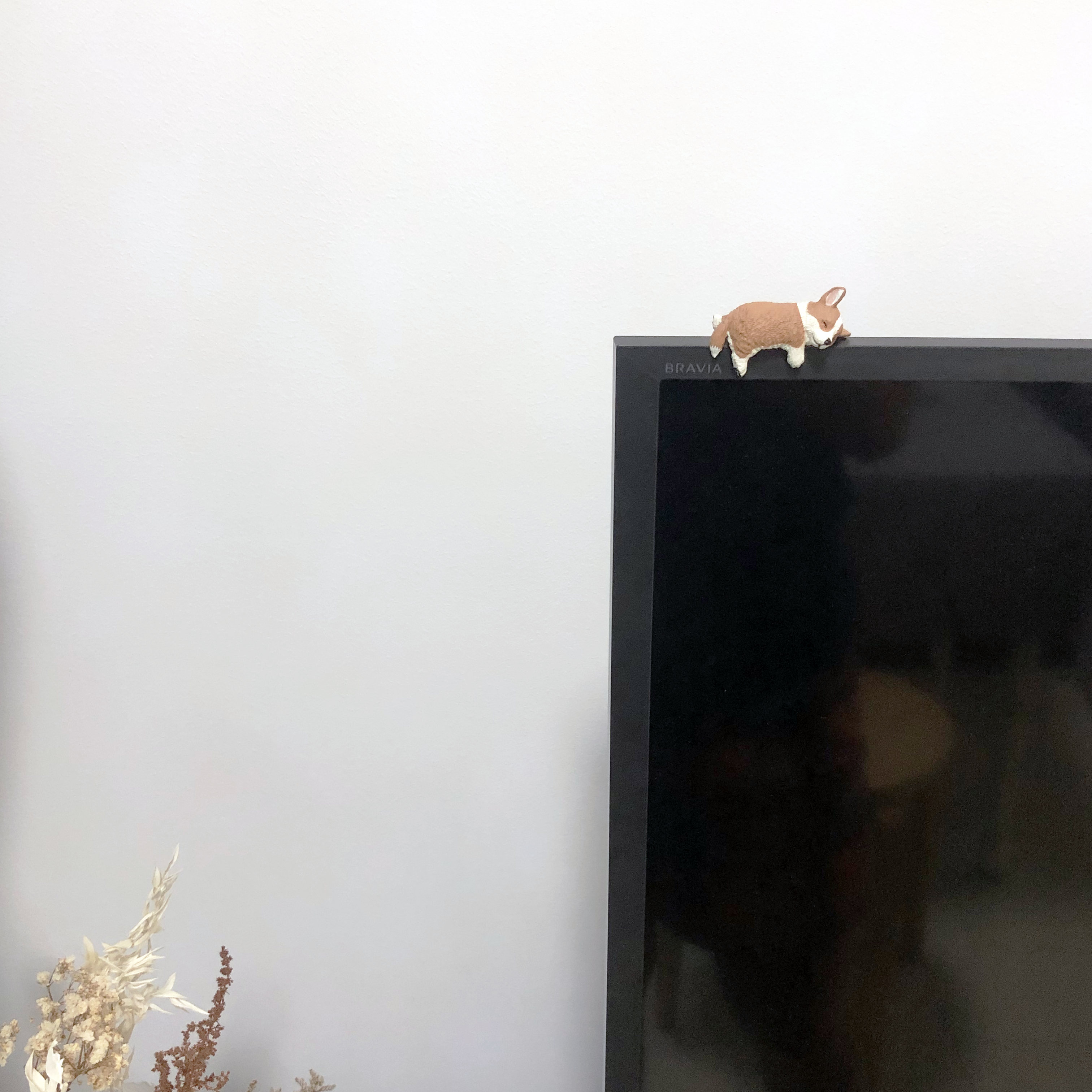 My Home Away From Home - Cute toy rabbit on TV screen, minimalist decor, white wall background, black flat-screen TV