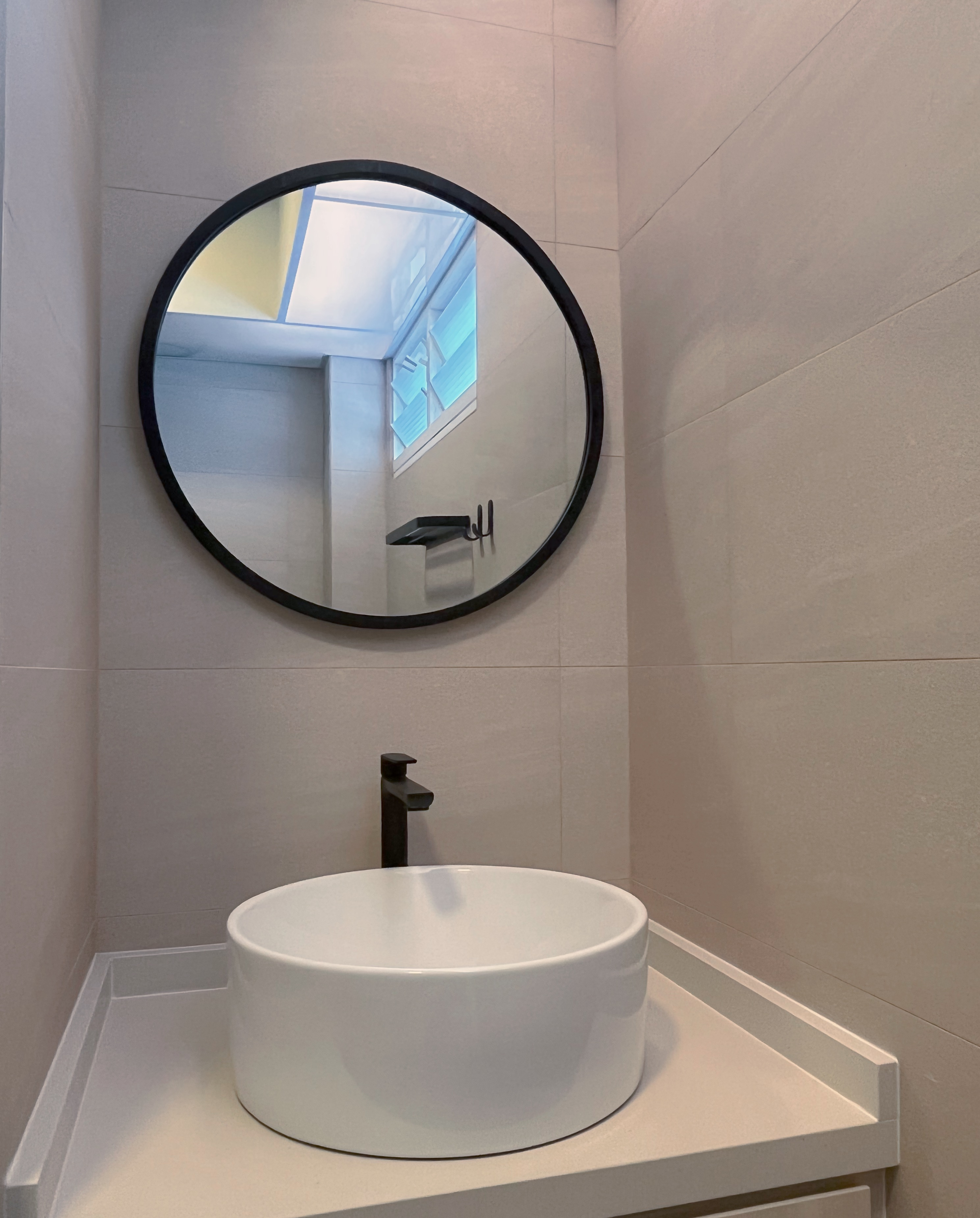 Living In A Cosy 3-room Flat with Minimal Housekeeping - Modern bathroom vanity, round mirror, white basin, sleek faucet