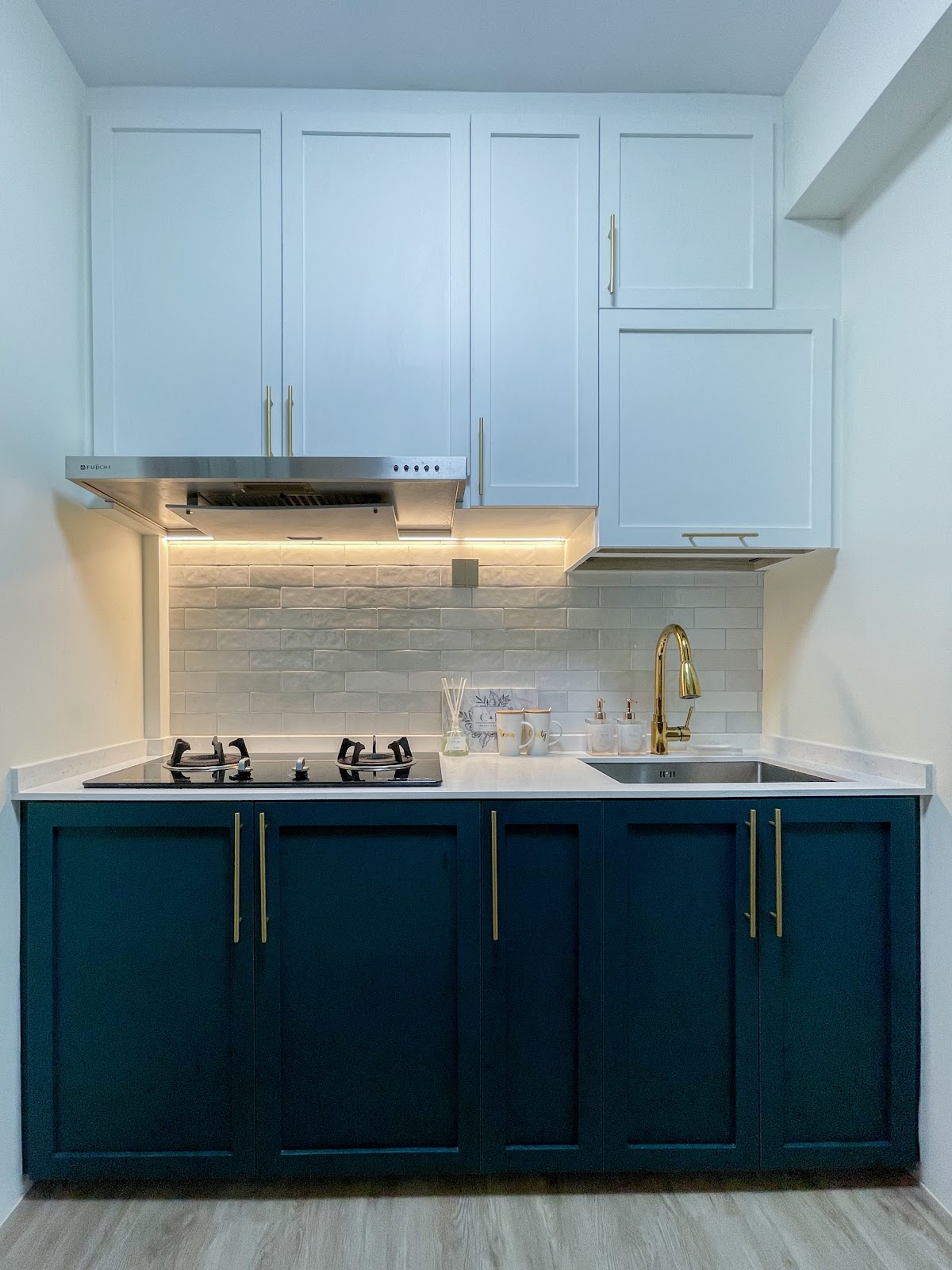 Modern Home for the Modern Interracial Couple - White kitchen cabinets, stainless steel range hood, under-cabinet lighting