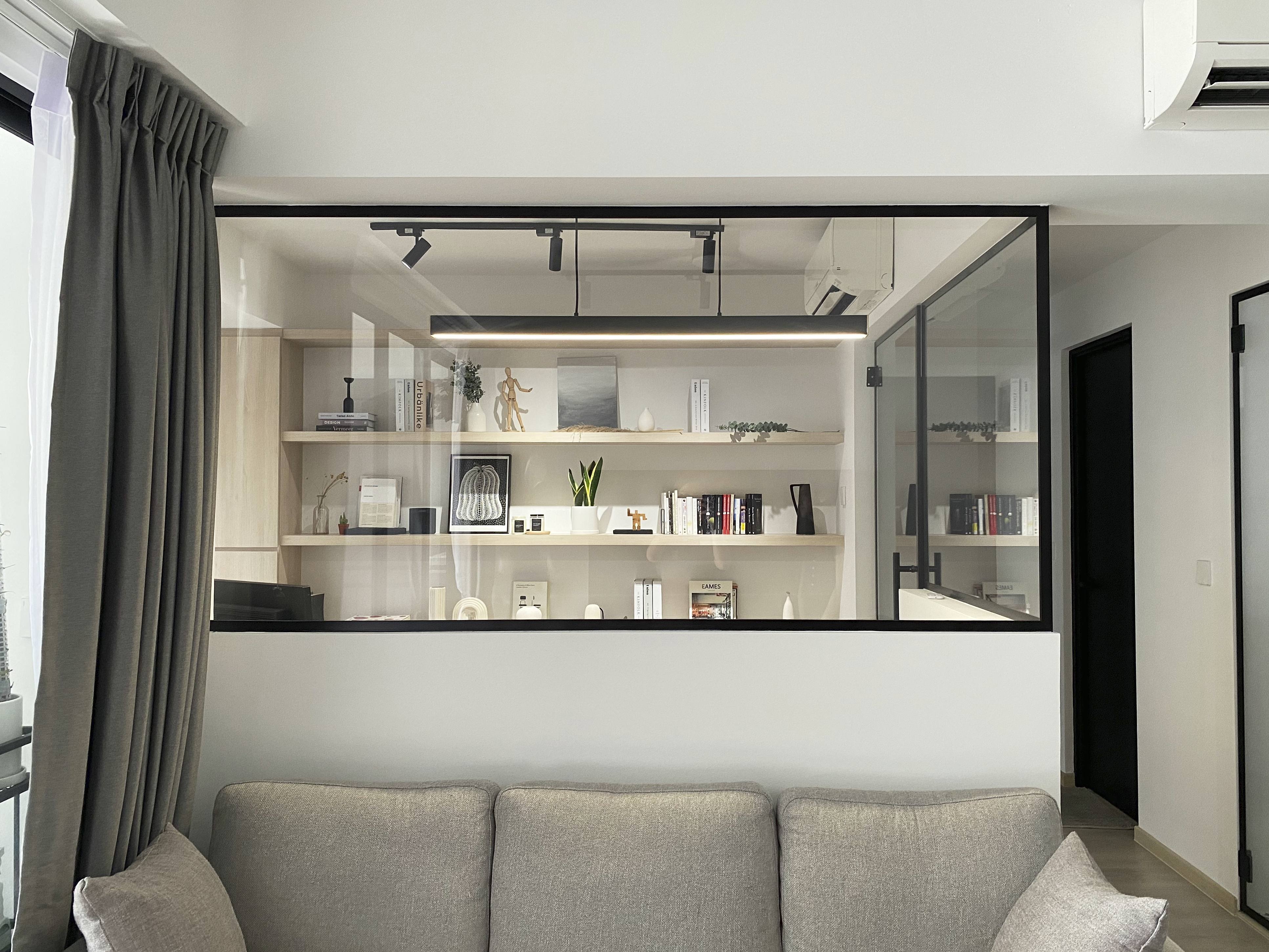 A Minimalist Apartment with an Urban Jungle - Modern minimalist living room, sleek entertainment center, built-in shelving