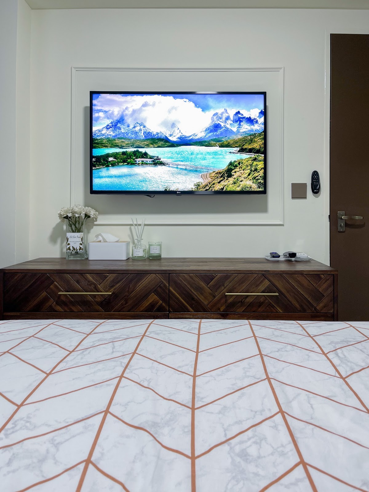 Modern Home for the Modern Interracial Couple - Modern bedroom with a large flat-screen TV displaying a breathtaking mountain