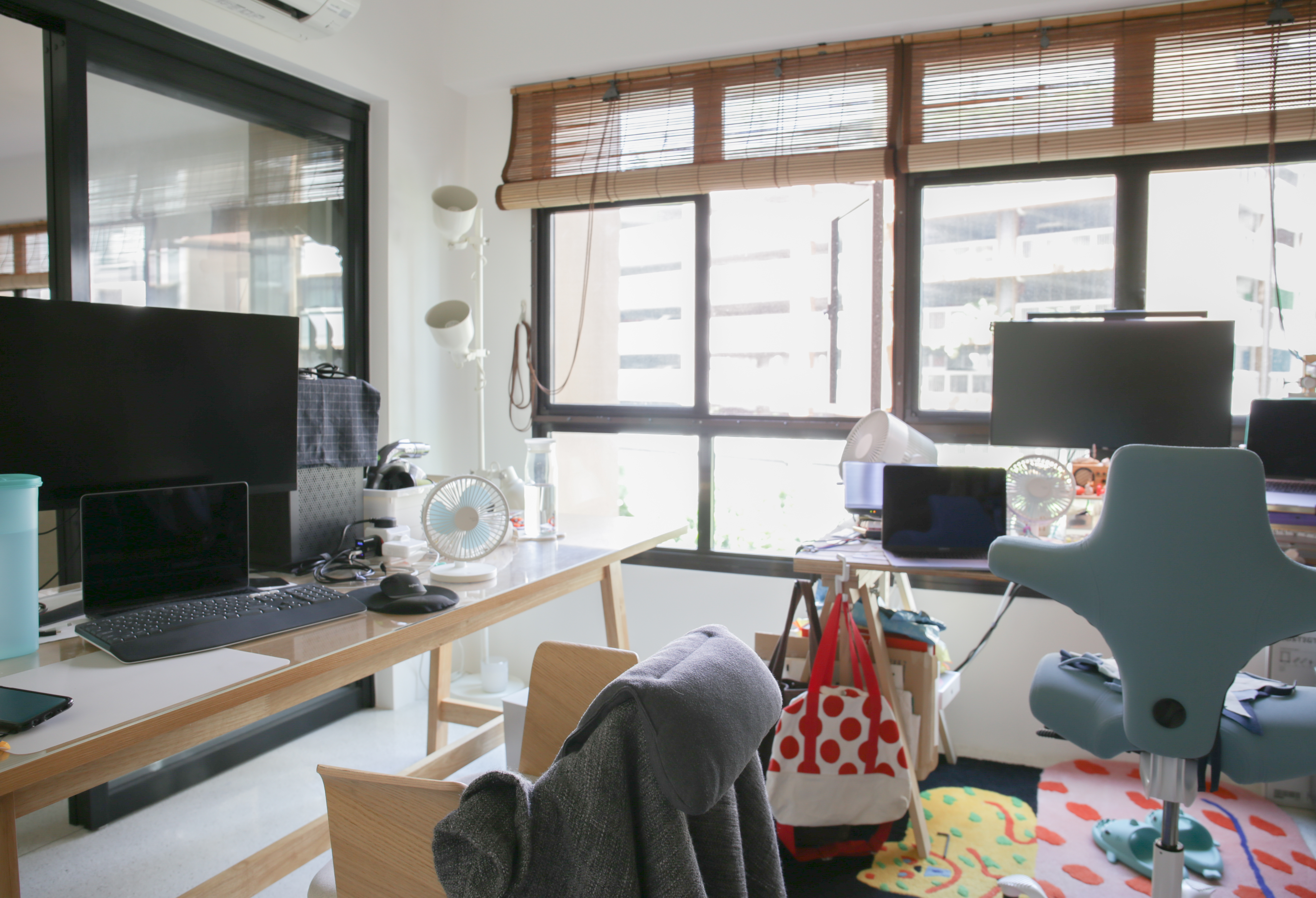 The Eccentricity of an Artistic Couple’s Apartment - Workspace, desk, computer, laptop, keyboard, monitor, chair, fan