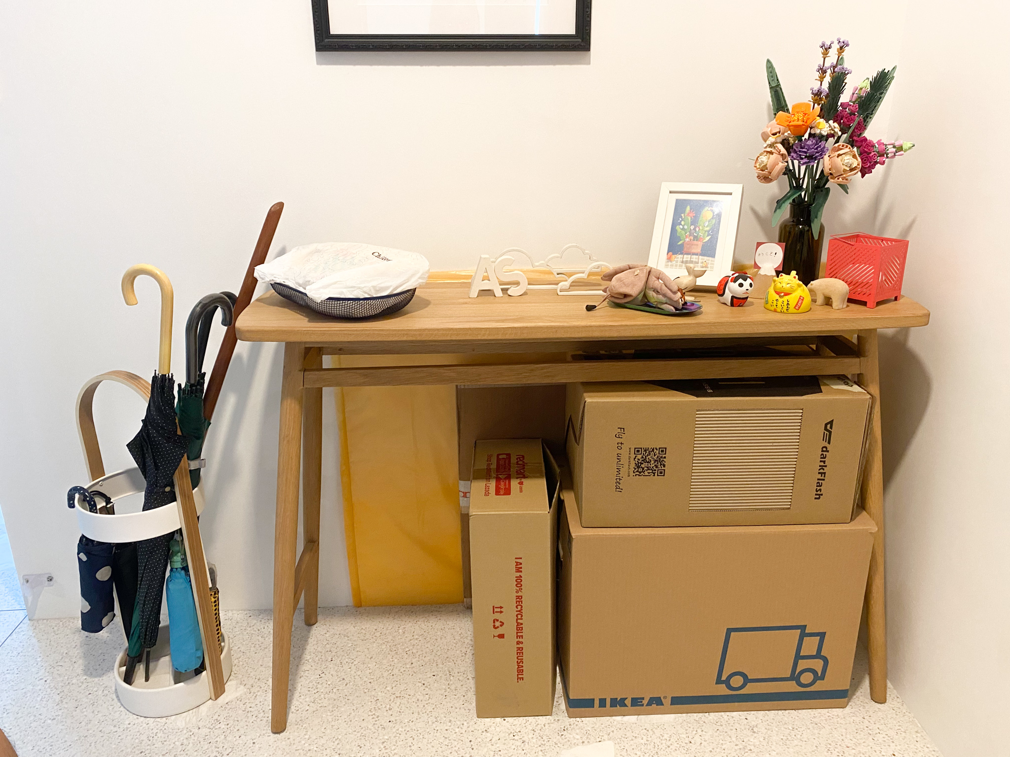 The Eccentricity of an Artistic Couple’s Apartment - Upholstered wooden desk, minimalist decor, colorful flowers, black and