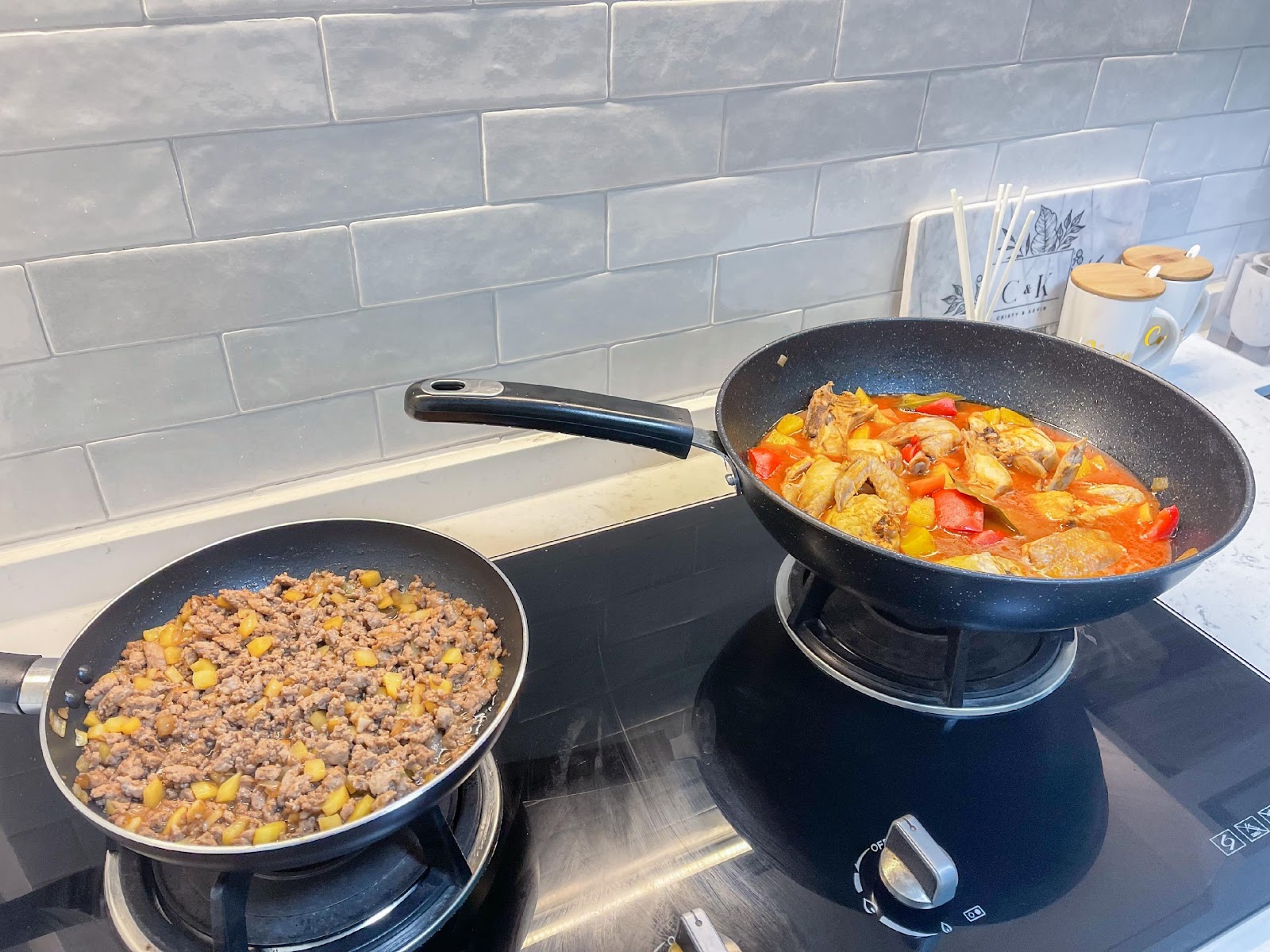Modern Home for the Modern Interracial Couple - stainless steel stovetop, black frying pans, two cooking pans, food