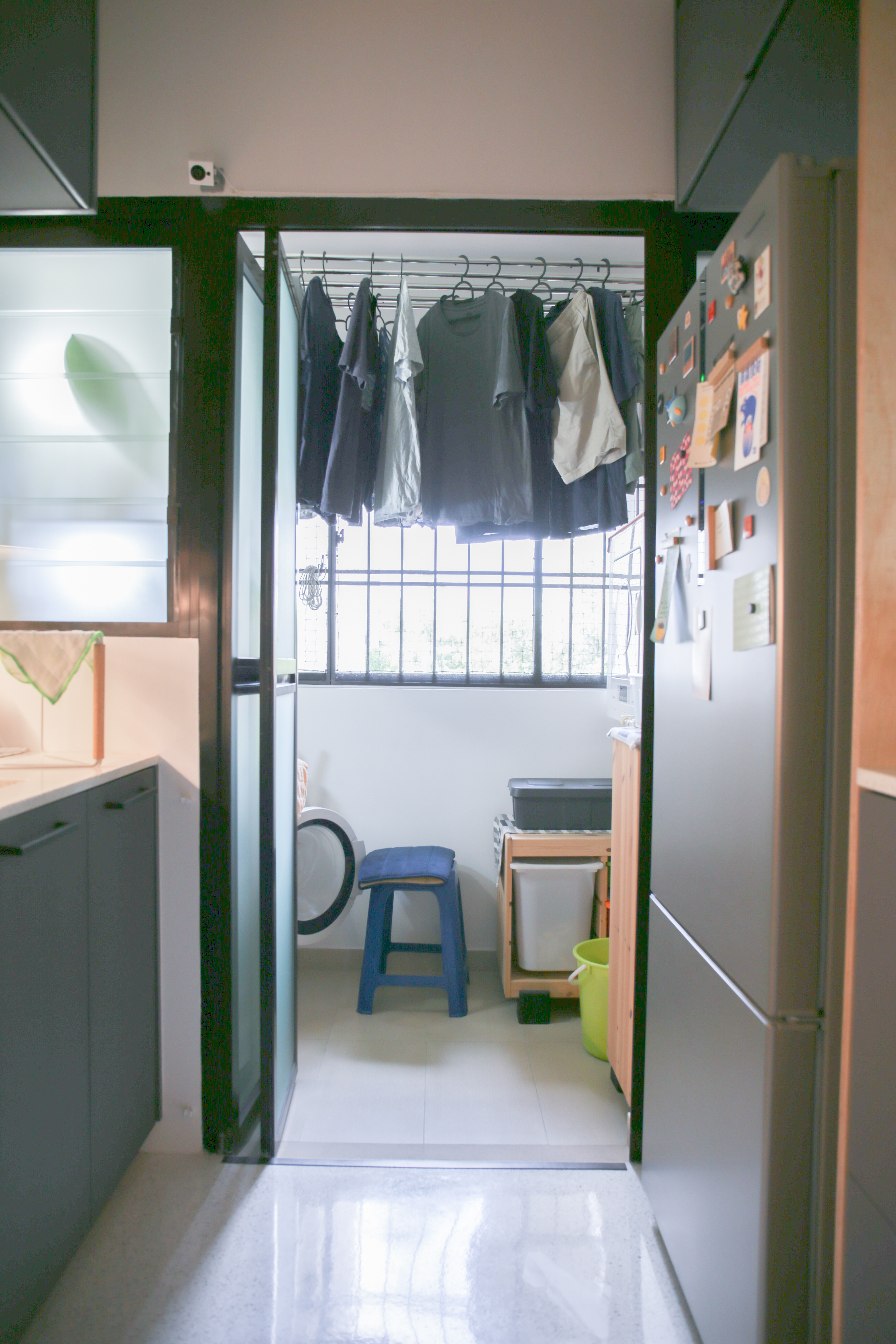 The Eccentricity of an Artistic Couple’s Apartment - kitchen, laundry room, refrigerator, clothes rack, hanging clothes