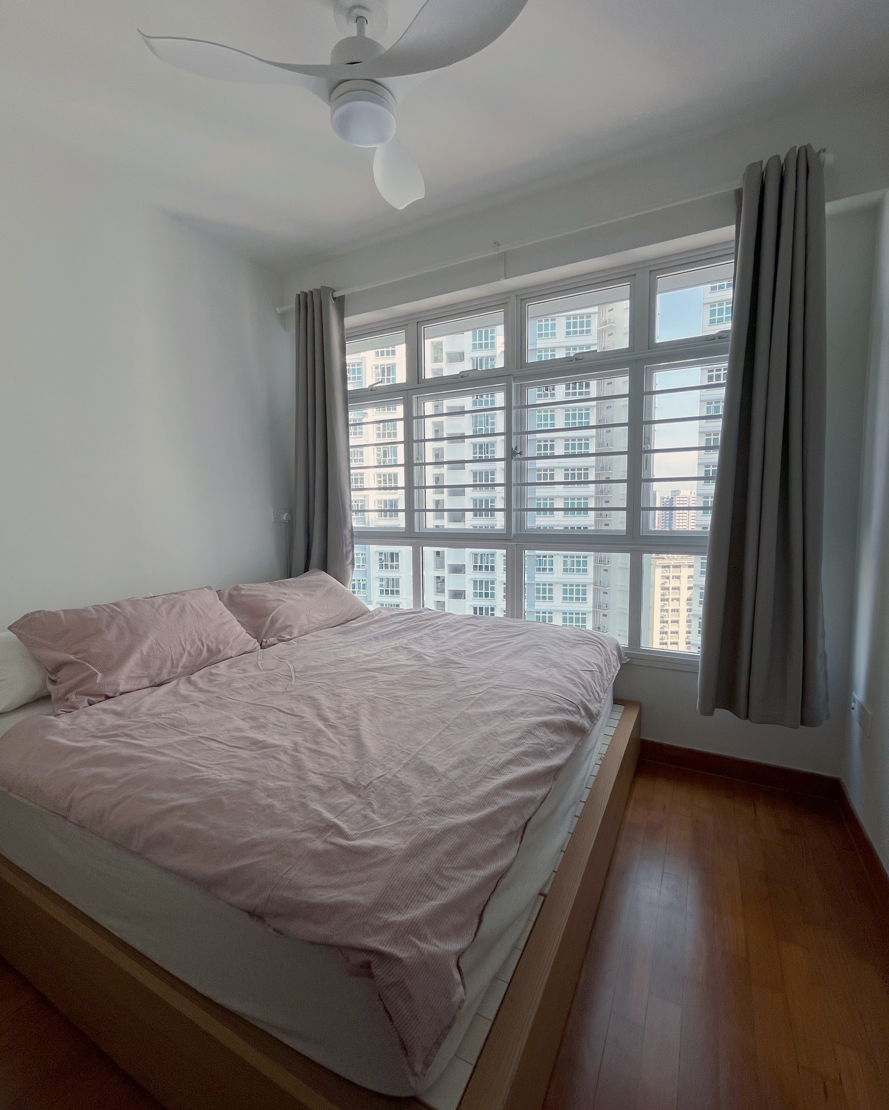 Living In A Cosy 3-room Flat with Minimal Housekeeping - Modern bedroom with large window, pink bedding, wooden floor