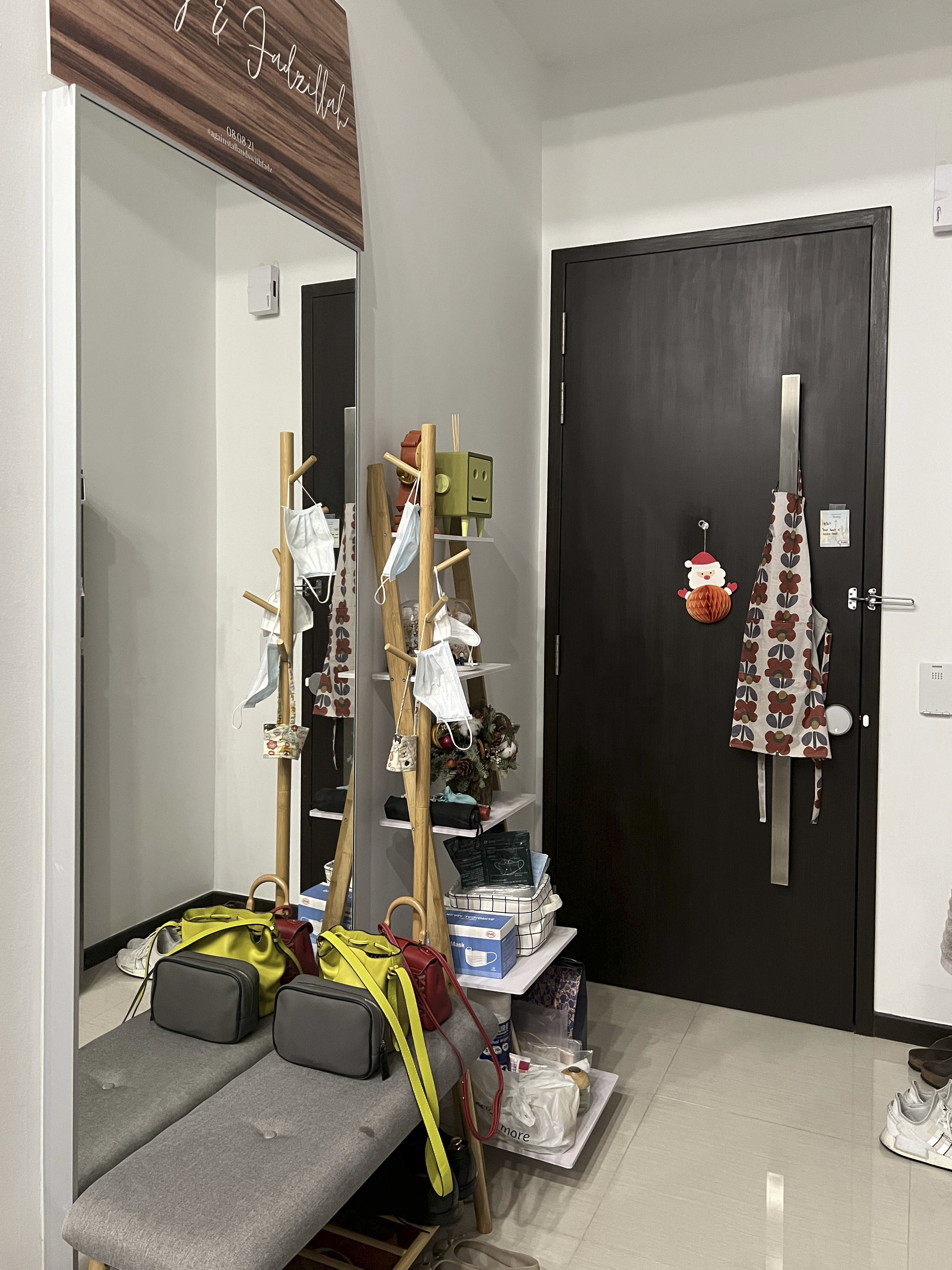 Our Smart Apartment That Might Be Smarter Than Us - Wooden rack, white face masks, festive decorations, black door, patterned