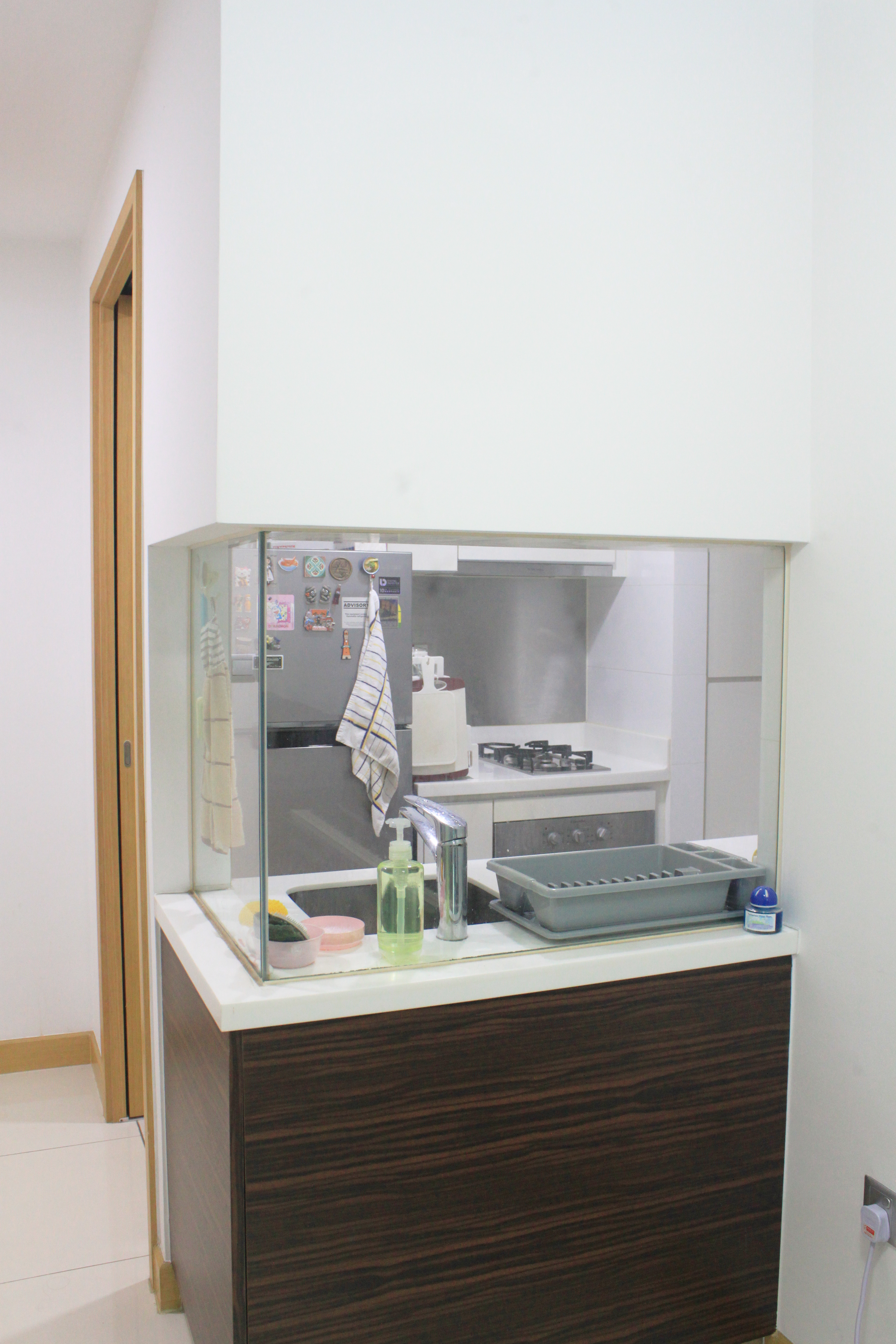 My Home Away From Home - Kitchen counter, refrigerator, towels, dish rack, soap dispenser, glass cabinet, white tiled floor