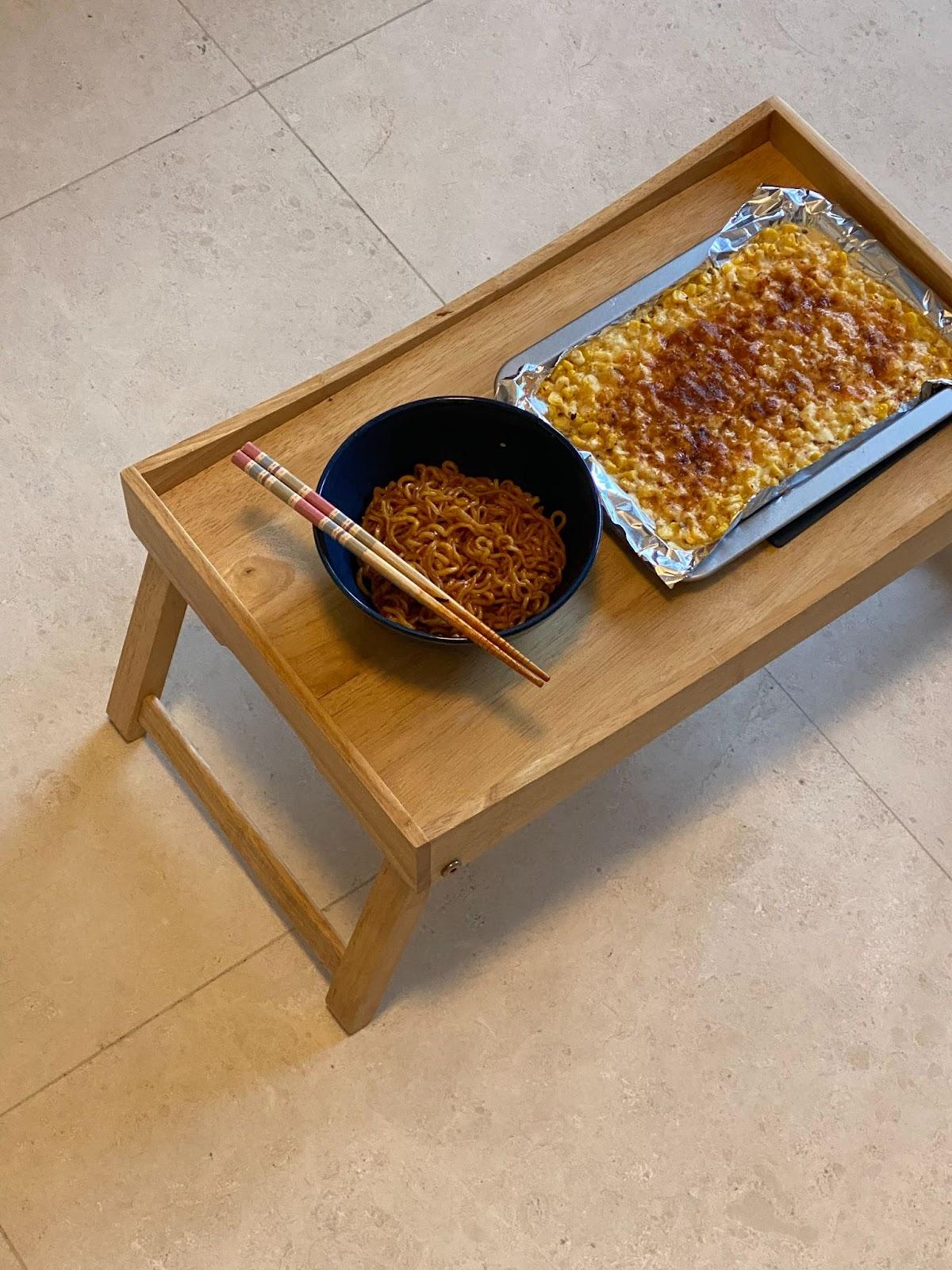 A Photographer's One-Room Studio Man Cave - wooden table, meal setup, noodle bowl, chopsticks, baked dish, aluminum foil