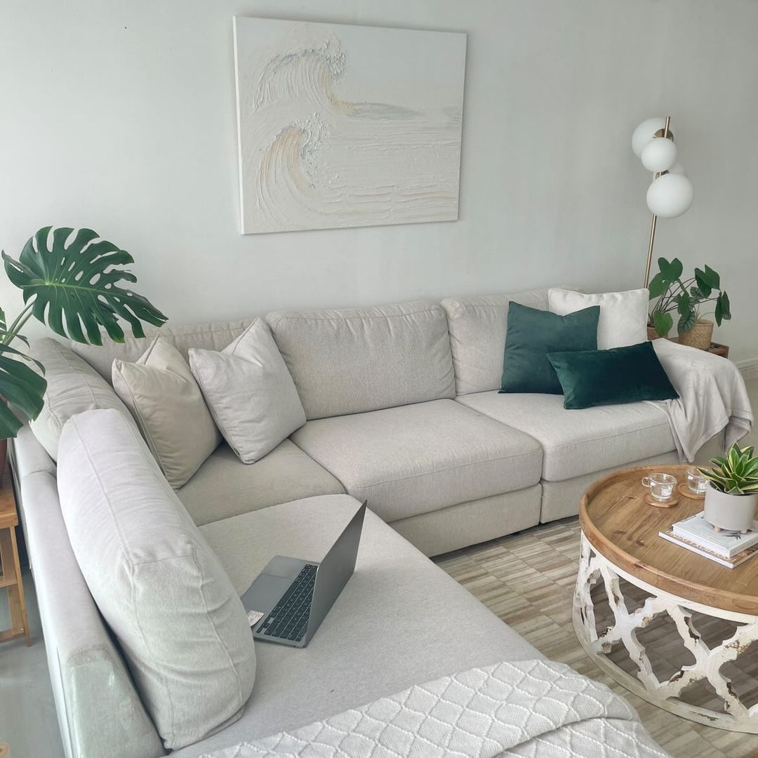 This home is the reflections of our likings - Light gray sectional sofa, minimalist decor, natural light, white walls, green