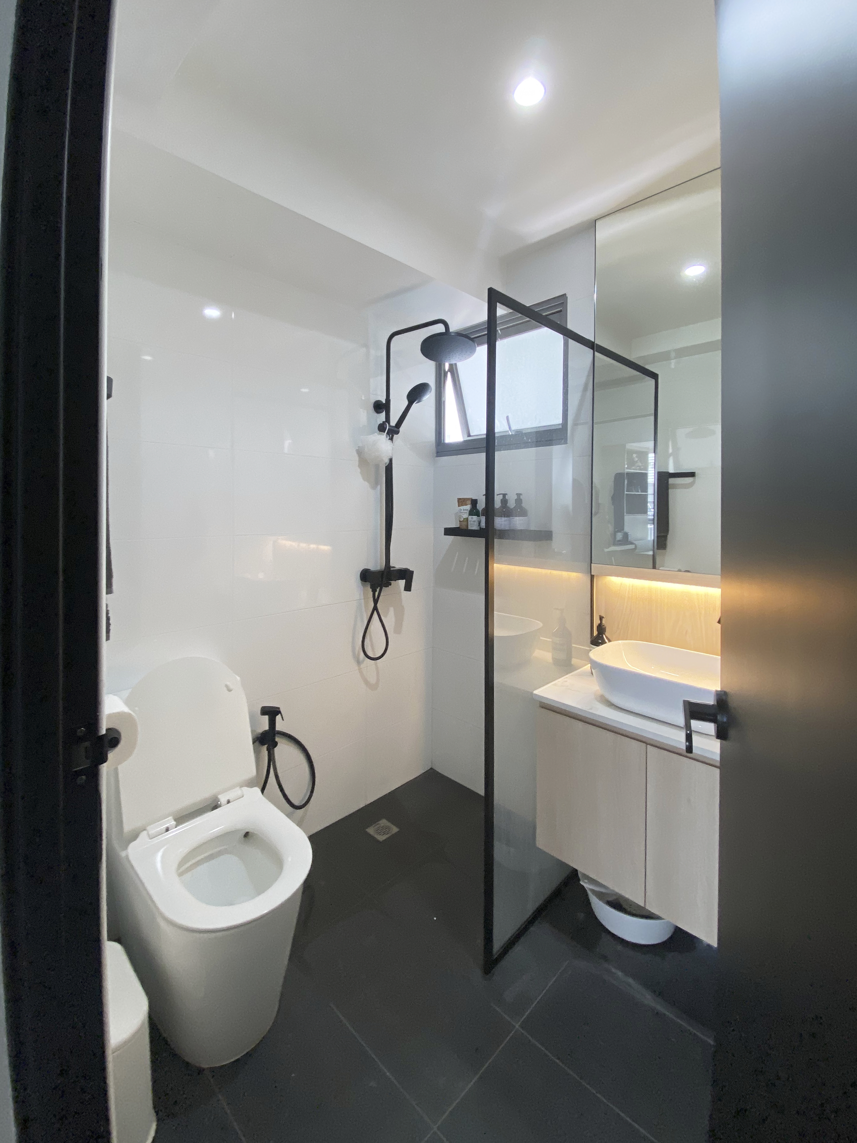 A Minimalist Apartment with an Urban Jungle - Modern minimalist bathroom, sleek design, white tiled walls, black shower rod