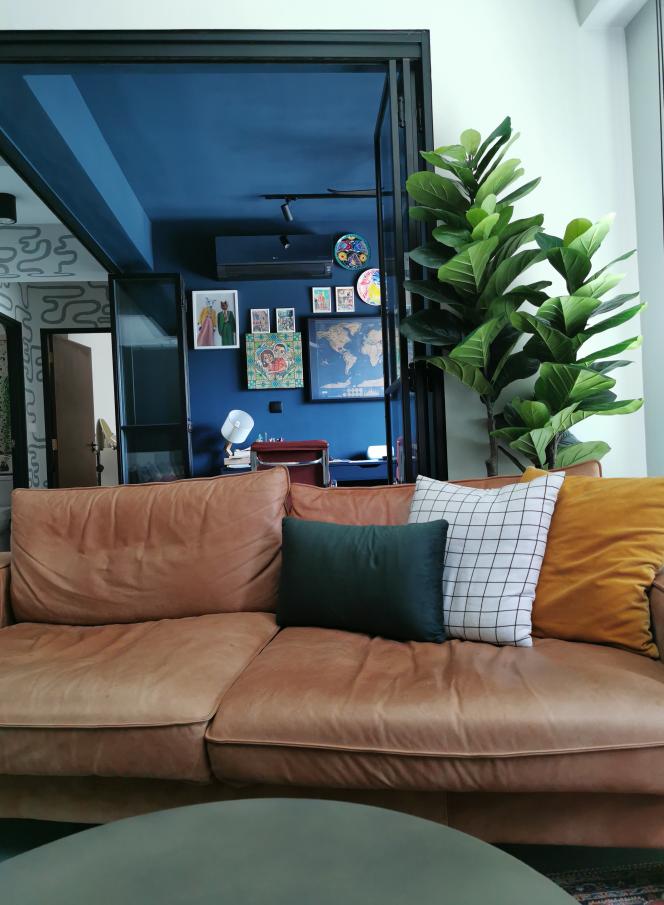 An atmosphere of darkness but comfortable for us - Modern living room, cozy seating, brown leather couch, green and yellow