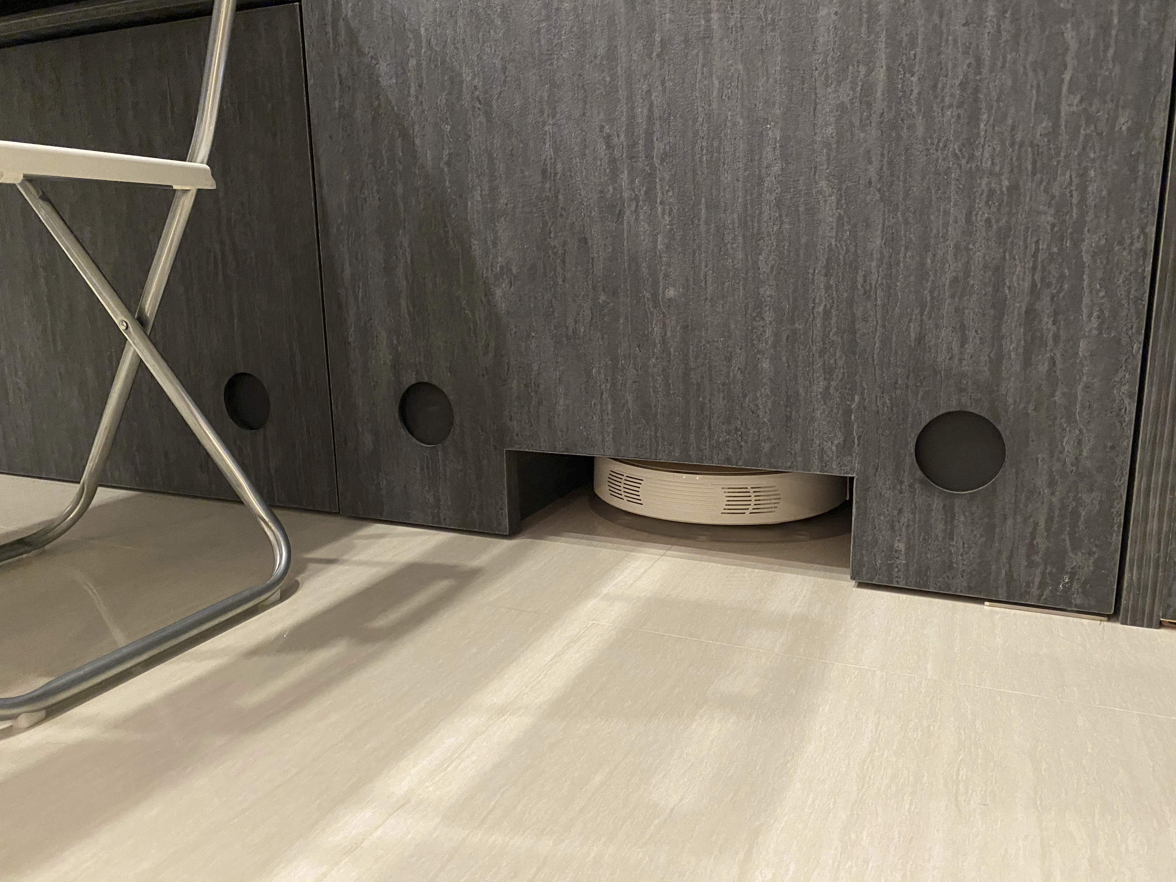 Our Smart Apartment That Might Be Smarter Than Us - modern storage unit, minimalist design, dark wood finish, circular holes