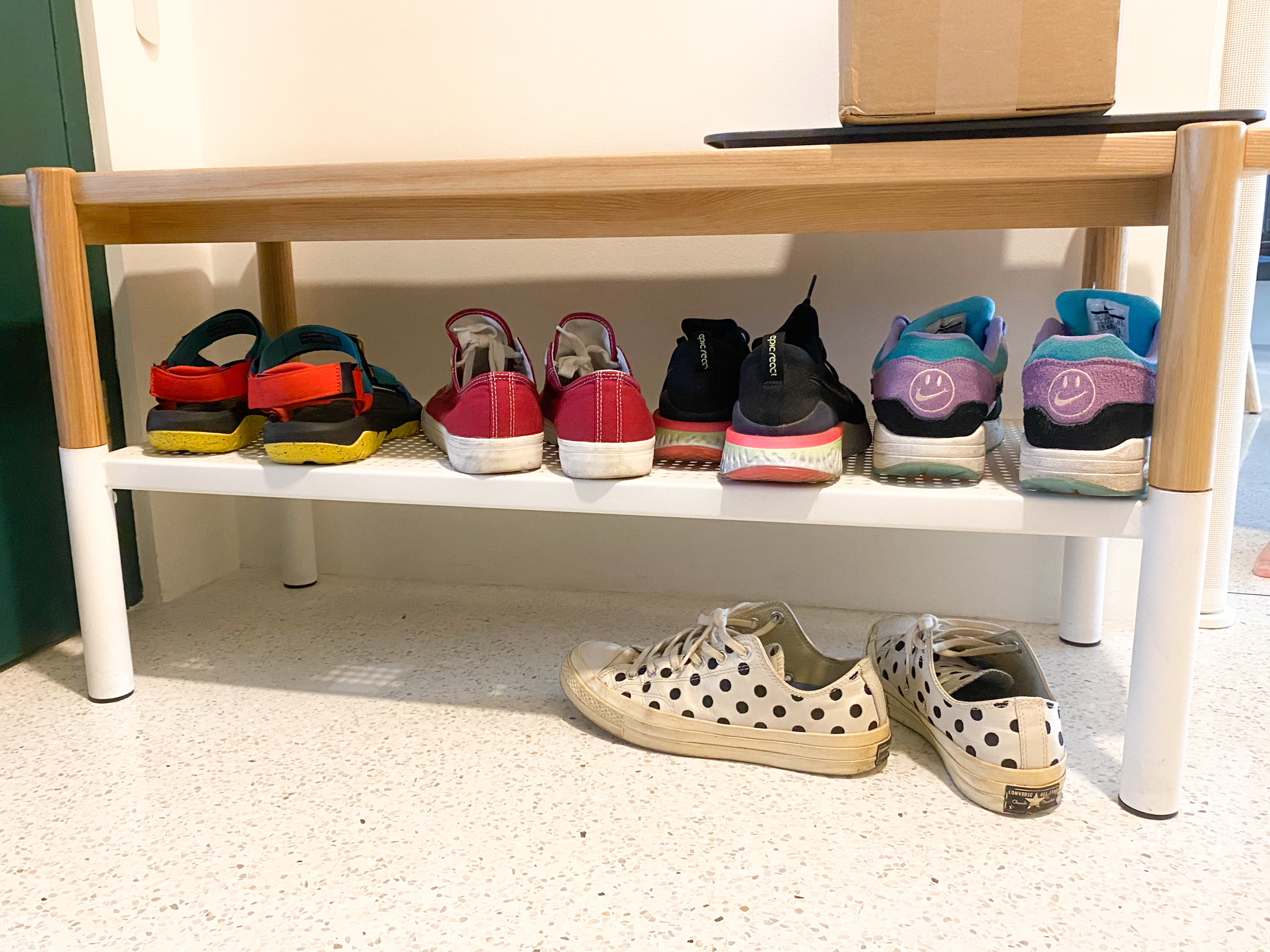 The Eccentricity of an Artistic Couple’s Apartment - Colorful sneakers on white shelf, various styles and colors, black and
