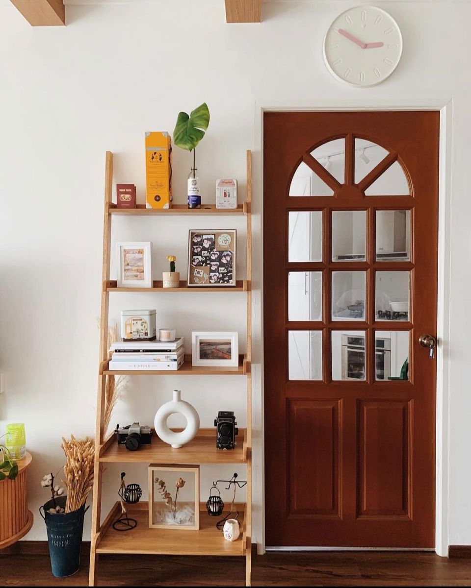 Created our version of modern farmhouse - Wooden shelf, decorative items, indoor plants, framed photos, vintage camera, small