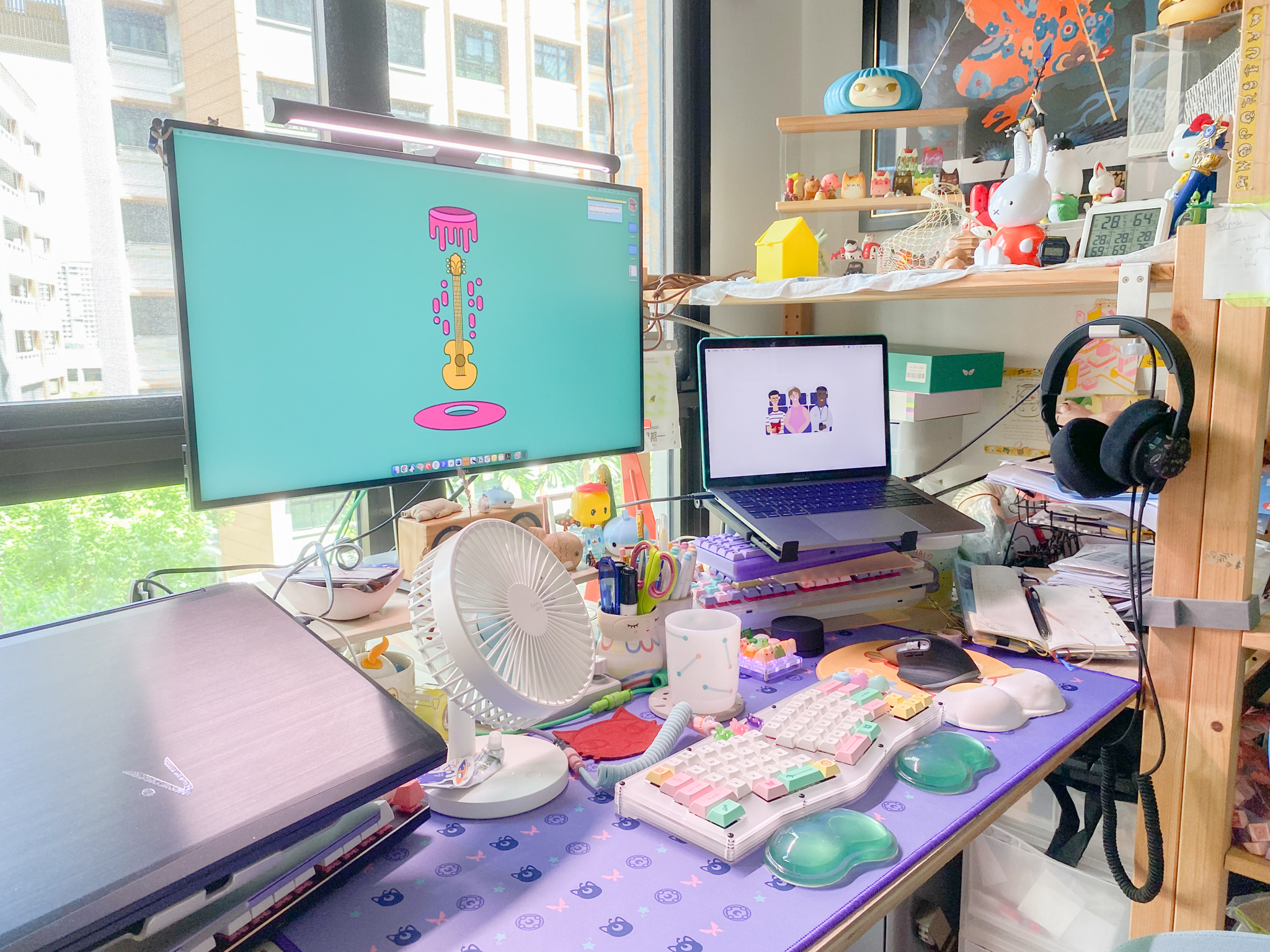 The Eccentricity of an Artistic Couple’s Apartment - Colorful desk, cluttered workspace, various items, desk fan, laptop