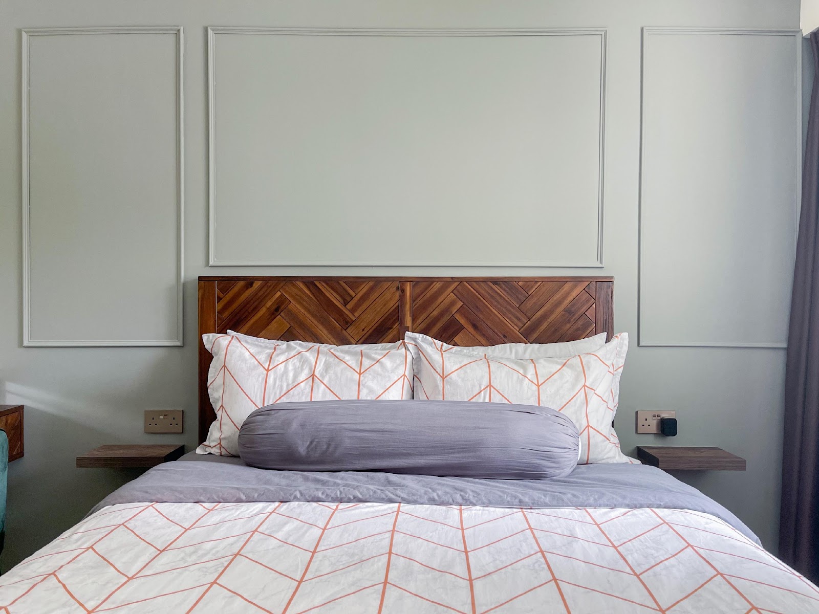 Modern Home for the Modern Interracial Couple - Modern bedroom with geometric patterned bedding, wooden herringbone